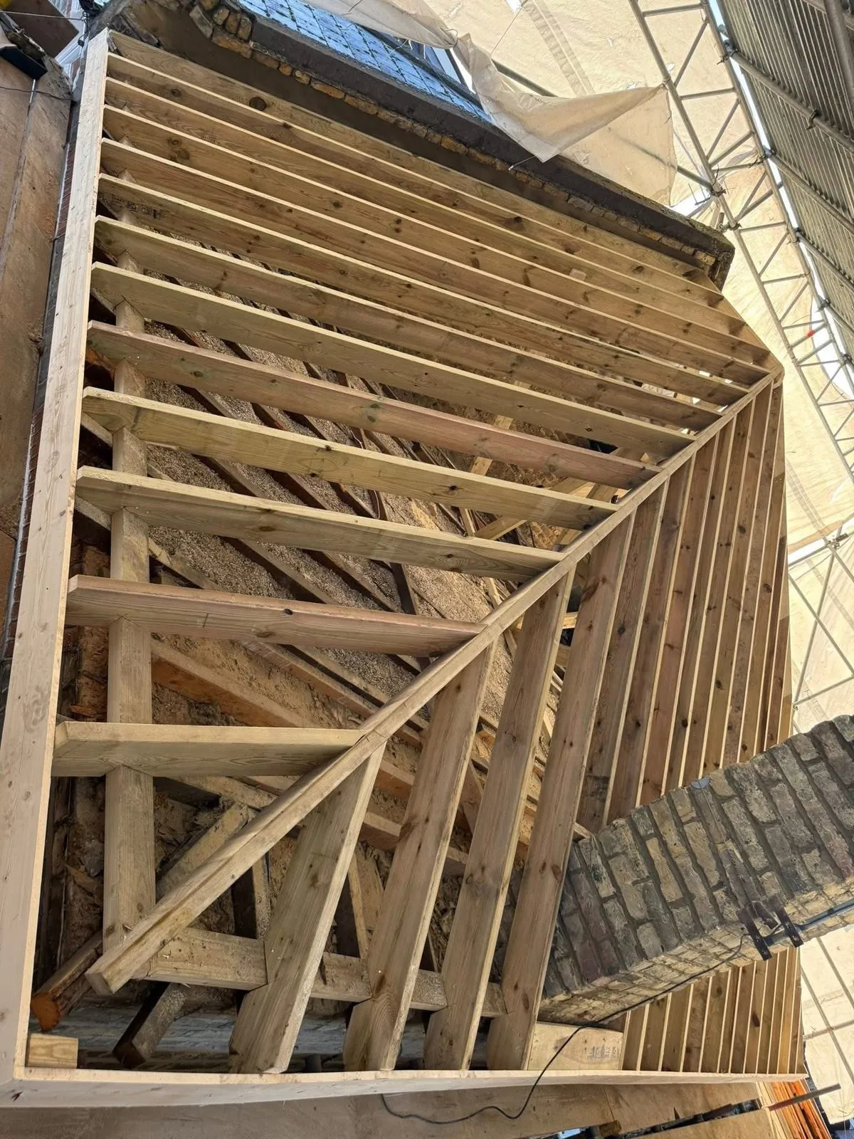 New roof timbers and rafters during a re-roof in Mullion